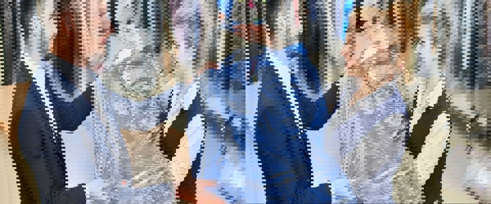 Man Giving Woman Dry Cleaned Clothes Min